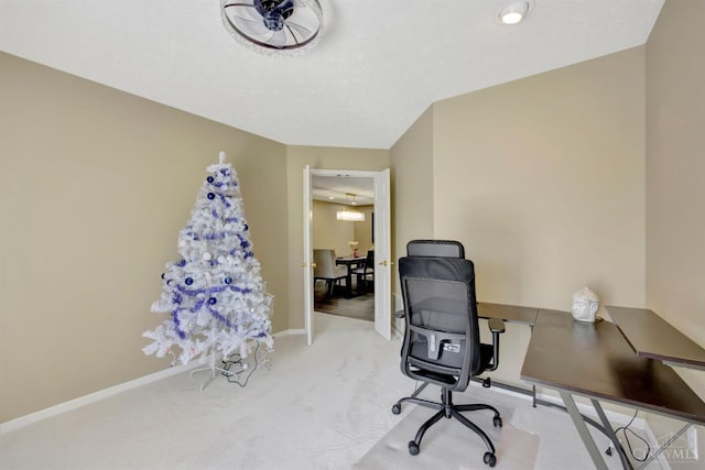 carpeted office space featuring baseboards