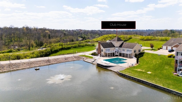 swimming pool featuring a patio area, a yard, and a water view