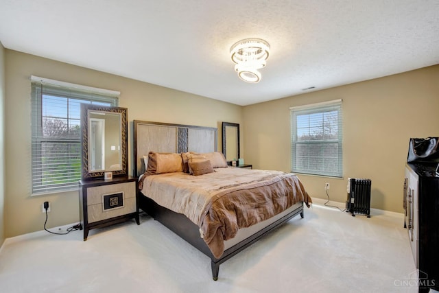 carpeted bedroom with baseboards and radiator heating unit