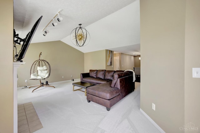 living area with rail lighting, carpet, baseboards, and vaulted ceiling