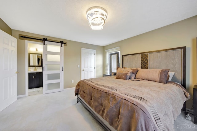 bedroom featuring a barn door, light carpet, baseboards, and connected bathroom