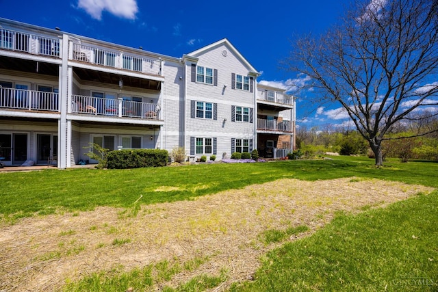 rear view of house featuring a lawn