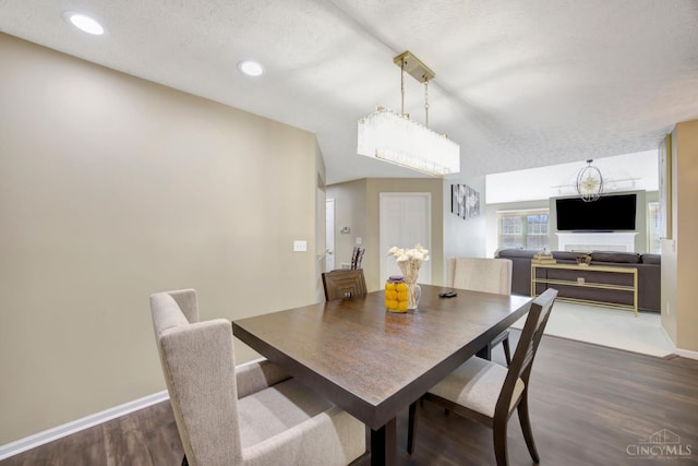 dining room featuring a textured ceiling, dark wood-style flooring, baseboards, and recessed lighting
