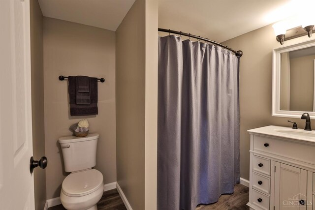 640 Frye Rd, Clay Twp, OH 45171 - bathroom featuring toilet, vanity, wood finished floors, and baseboards