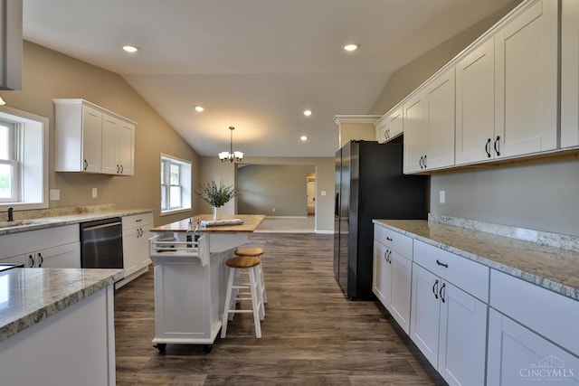 640 Frye Rd, Clay Twp, OH 45171 - kitchen with vaulted ceiling, white cabinetry, stainless steel appliances, dark wood-style flooring, and a breakfast bar area