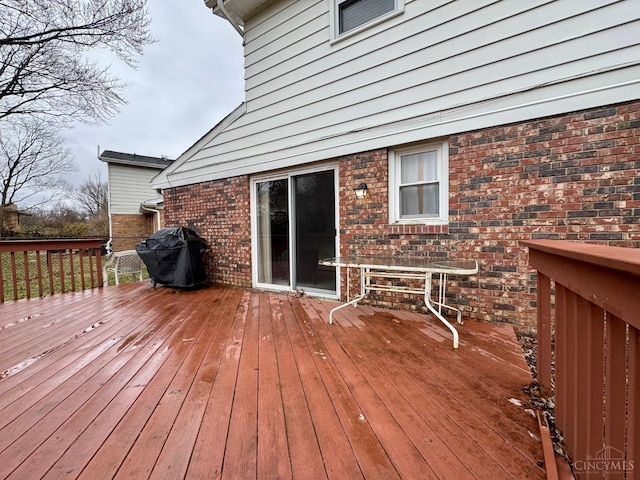 wooden terrace featuring area for grilling