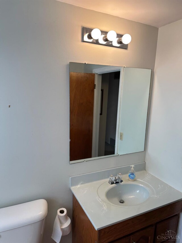bathroom featuring toilet and vanity