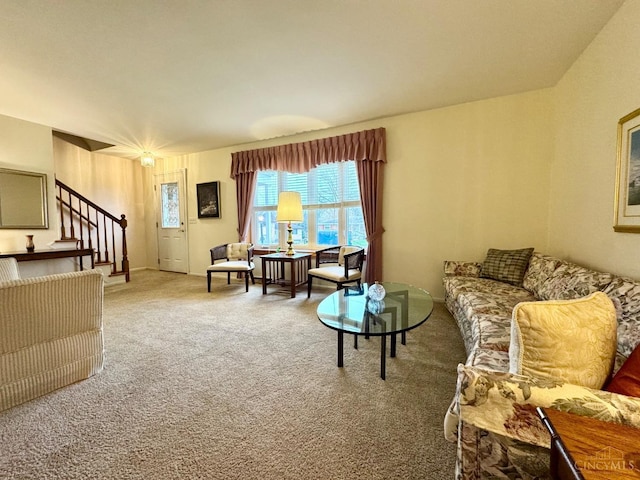 carpeted living room with stairway and plenty of natural light