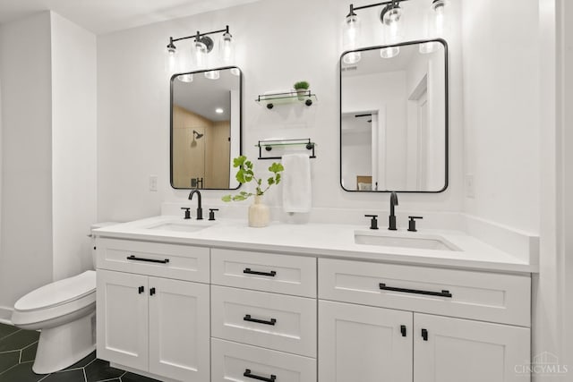 full bath featuring toilet, tile patterned floors, double vanity, and a shower
