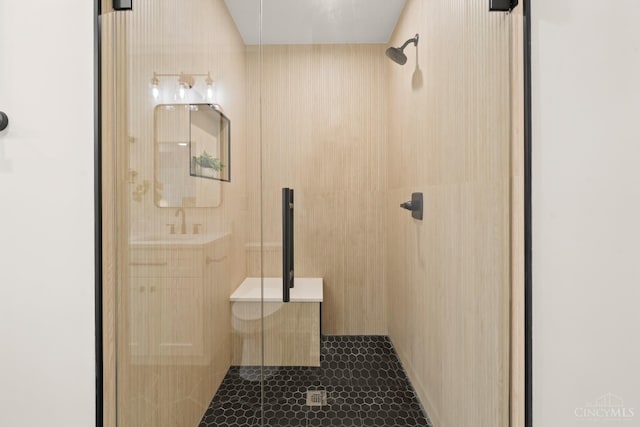 bathroom with a shower stall and tile patterned flooring