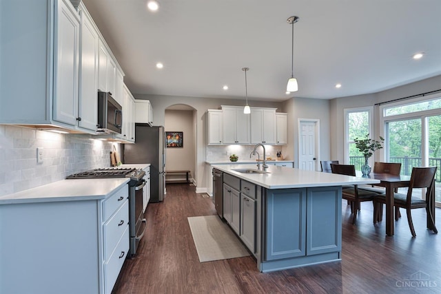 7690 Wharton Ct, West Chester, OH 45069 - kitchen featuring appliances with stainless steel finishes, arched walkways, light countertops, dark wood-style floors, and recessed lighting