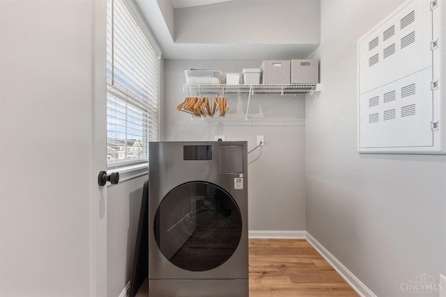 5880 Parkview Ln Unit 303, Miami Twp, OH 45150 - laundry room featuring washer / dryer, light wood finished floors, and baseboards