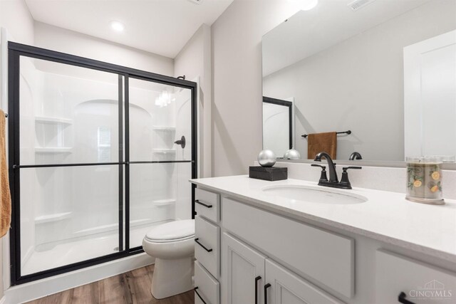 5880 Parkview Ln Unit 303, Miami Twp, OH 45150 - full bath with wood finished floors, a shower stall, toilet, and vanity