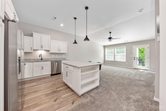 5880 Parkview Ln Unit 303, Miami Twp, OH 45150 - kitchen featuring stainless steel appliances, a sink, open shelves, ceiling fan, and white cabinetry