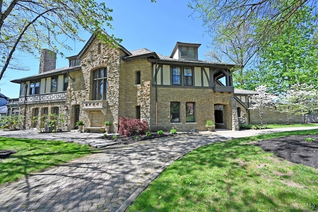 1 Beech Crest Ln, Cincinnati, OH 45206 - tudor house with stone siding, a chimney, and a front lawn