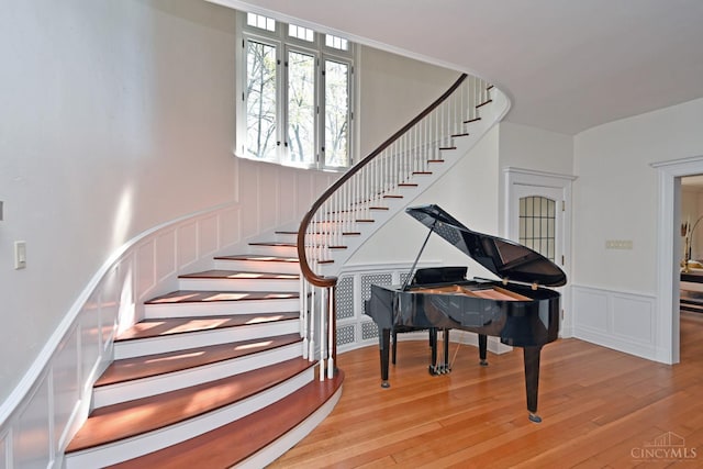 1 Beech Crest Ln, Cincinnati, OH 45206 - staircase featuring wood finished floors, a decorative wall, and wainscoting