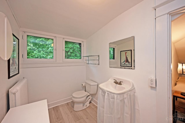 1 Beech Crest Ln, Cincinnati, OH 45206 - ensuite bathroom with radiator heating unit, wood finished floors, toilet, baseboards, and a sink
