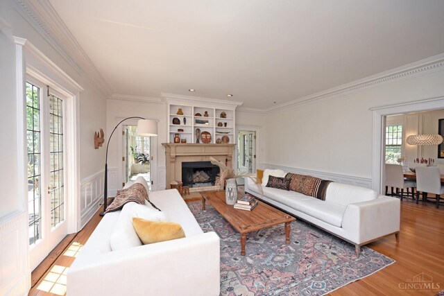 1 Beech Crest Ln, Cincinnati, OH 45206 - living area with ornamental molding, light wood-type flooring, a wainscoted wall, a fireplace, and a decorative wall