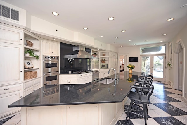 1 Beech Crest Ln, Cincinnati, OH 45206 - kitchen with built in appliances, open shelves, a sink, recessed lighting, and wall chimney exhaust hood