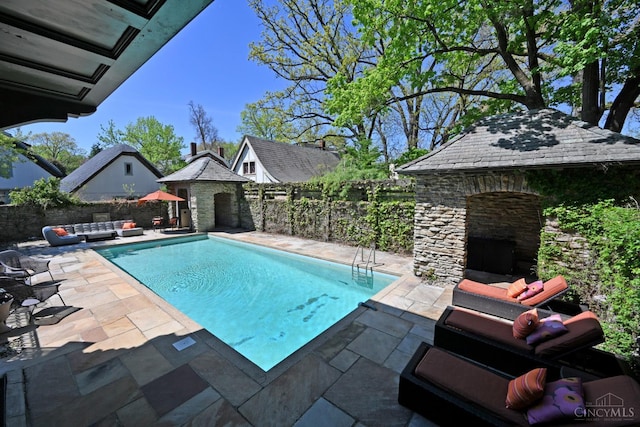 1 Beech Crest Ln, Cincinnati, OH 45206 - view of swimming pool with an outdoor living space with a fireplace, a patio area, a fenced backyard, and an outdoor structure