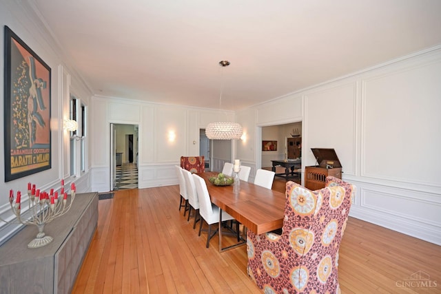 1 Beech Crest Ln, Cincinnati, OH 45206 - dining room with a decorative wall, light wood finished floors, and crown molding