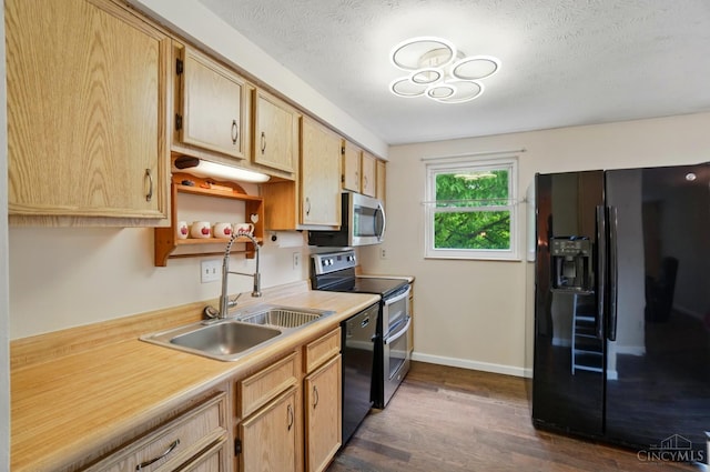 6289 Chablis Dr, Liberty Twp, OH 45011 - kitchen featuring black appliances, dark wood-style floors, light countertops, a sink, and baseboards