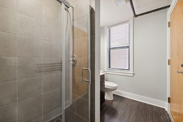 1406 Republic St Unit 102, Cincinnati, OH 45202 - bathroom featuring a stall shower, baseboards, toilet, and wood finished floors