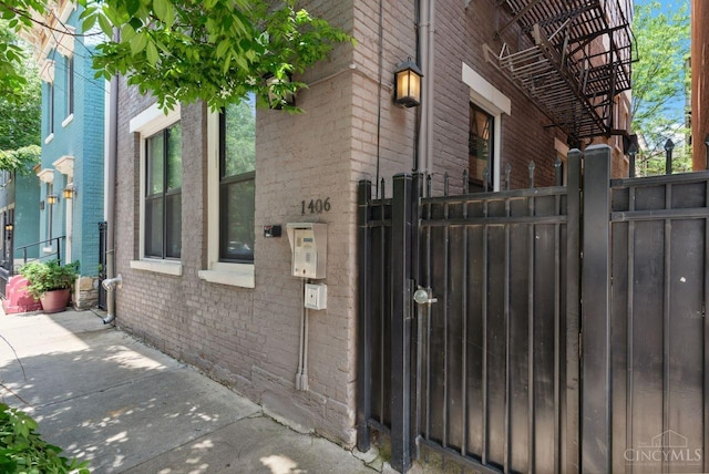 1406 Republic St Unit 102, Cincinnati, OH 45202 - view of property exterior with brick siding, a gate, and fence