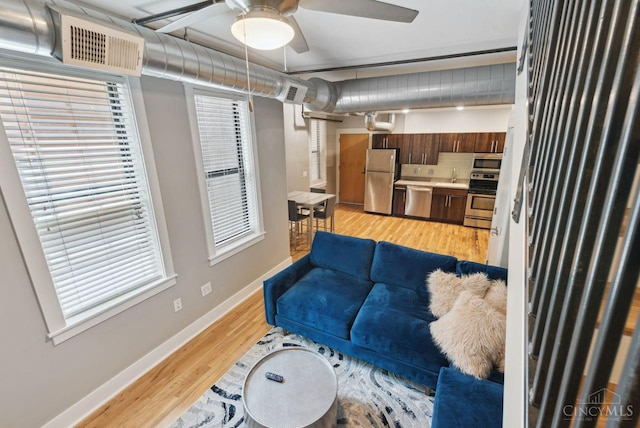 1406 Republic St Unit 102, Cincinnati, OH 45202 - living room with ceiling fan, light wood-type flooring, baseboards, and healthy amount of natural light