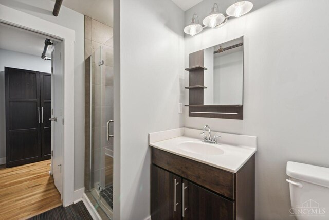 1406 Republic St Unit 102, Cincinnati, OH 45202 - bathroom with a stall shower, toilet, vanity, wood finished floors, and baseboards