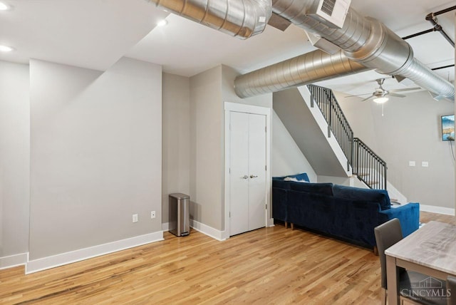 1406 Republic St Unit 102, Cincinnati, OH 45202 - basement featuring light wood-style flooring, baseboards, stairway, ceiling fan, and recessed lighting