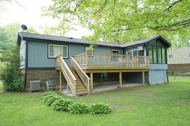 1260 Pine Forest Dr, Pierce Twp, OH 45102 - rear view of house featuring stairway, a wooden deck, a yard, a sunroom, and central AC unit