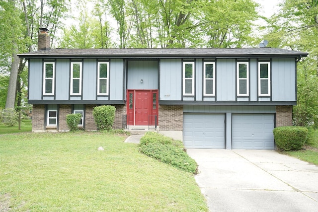 1260 Pine Forest Dr, Pierce Twp, OH 45102 - raised ranch featuring a chimney, a garage, brick siding, a front yard, and driveway