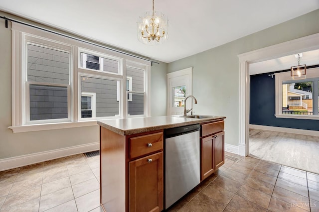 4604 Simpson Ave, Cincinnati, OH 45227 - kitchen featuring stainless steel dishwasher, a sink, light tile patterned floors, and a chandelier