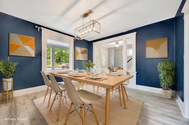 4604 Simpson Ave, Cincinnati, OH 45227 - dining room featuring baseboards, light wood-type flooring, and stairs