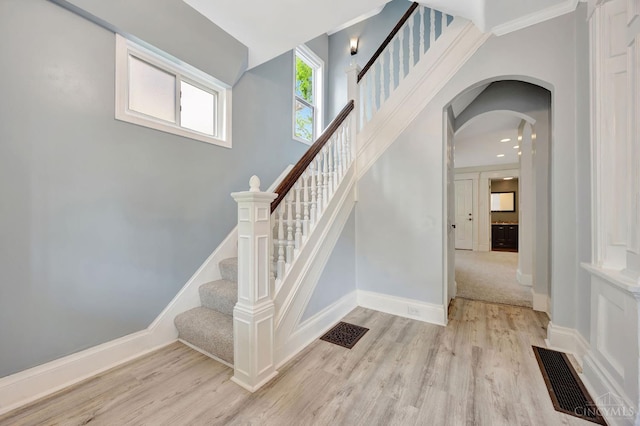 4604 Simpson Ave, Cincinnati, OH 45227 - stairway with wood finished floors, arched walkways, and baseboards