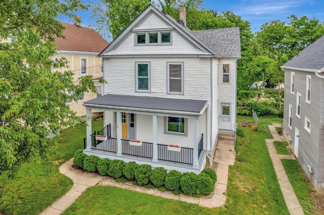 4604 Simpson Ave, Cincinnati, OH 45227 - victorian house featuring a porch, a chimney, a front lawn, and roof with shingles