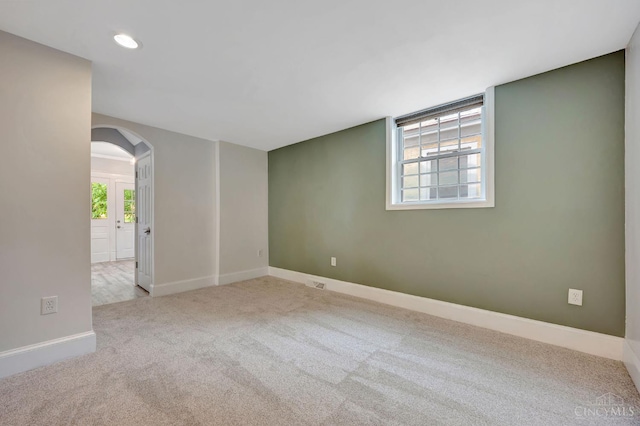 4604 Simpson Ave, Cincinnati, OH 45227 - spare room featuring arched walkways, carpet floors, healthy amount of natural light, baseboards, and recessed lighting