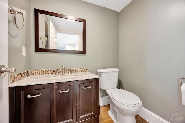 4604 Simpson Ave, Cincinnati, OH 45227 - bathroom featuring toilet, vanity, wood finished floors, and baseboards