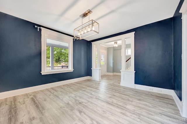 4604 Simpson Ave, Cincinnati, OH 45227 - spare room with wood finished floors, baseboards, stairway, and a chandelier