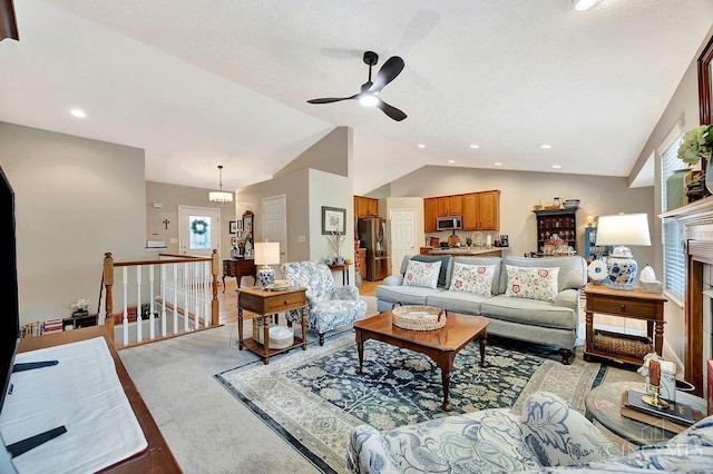 living room featuring lofted ceiling, ceiling fan, and recessed lighting