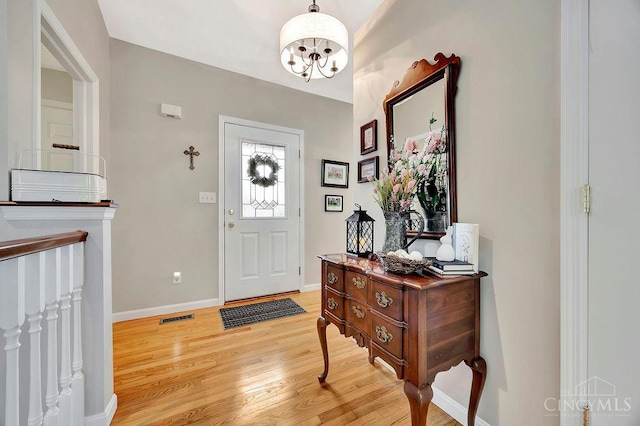 entrance foyer with light wood-style flooring and baseboards