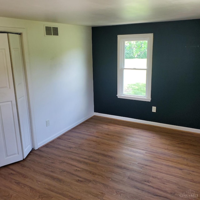 10595 Cozaddale Murdock St, Hamilton Twp, OH 45122 - unfurnished bedroom with dark wood-style floors, baseboards, and a closet