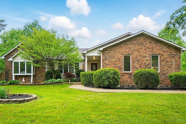view of front of property with brick siding and a front yard