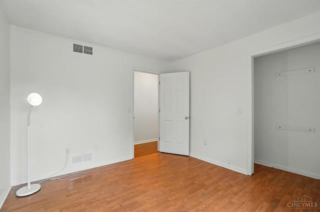 unfurnished bedroom featuring light wood-type flooring and baseboards
