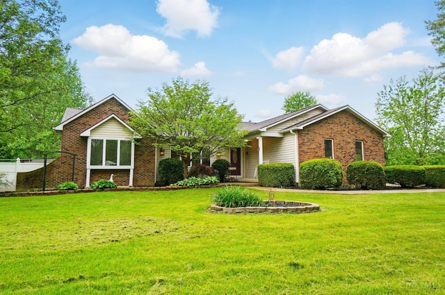 ranch-style home with brick siding and a front lawn