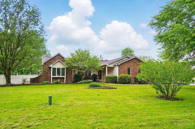 view of front of property featuring brick siding and a chimney