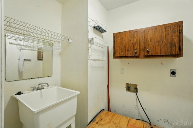 laundry room featuring cabinet space, hookup for a washing machine, and electric dryer hookup