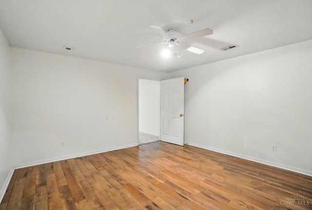 unfurnished room with wood-type flooring, ceiling fan, and baseboards