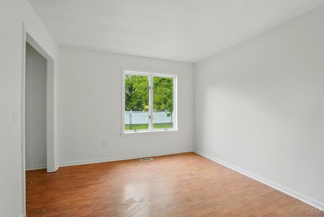 spare room with light wood-style flooring and baseboards